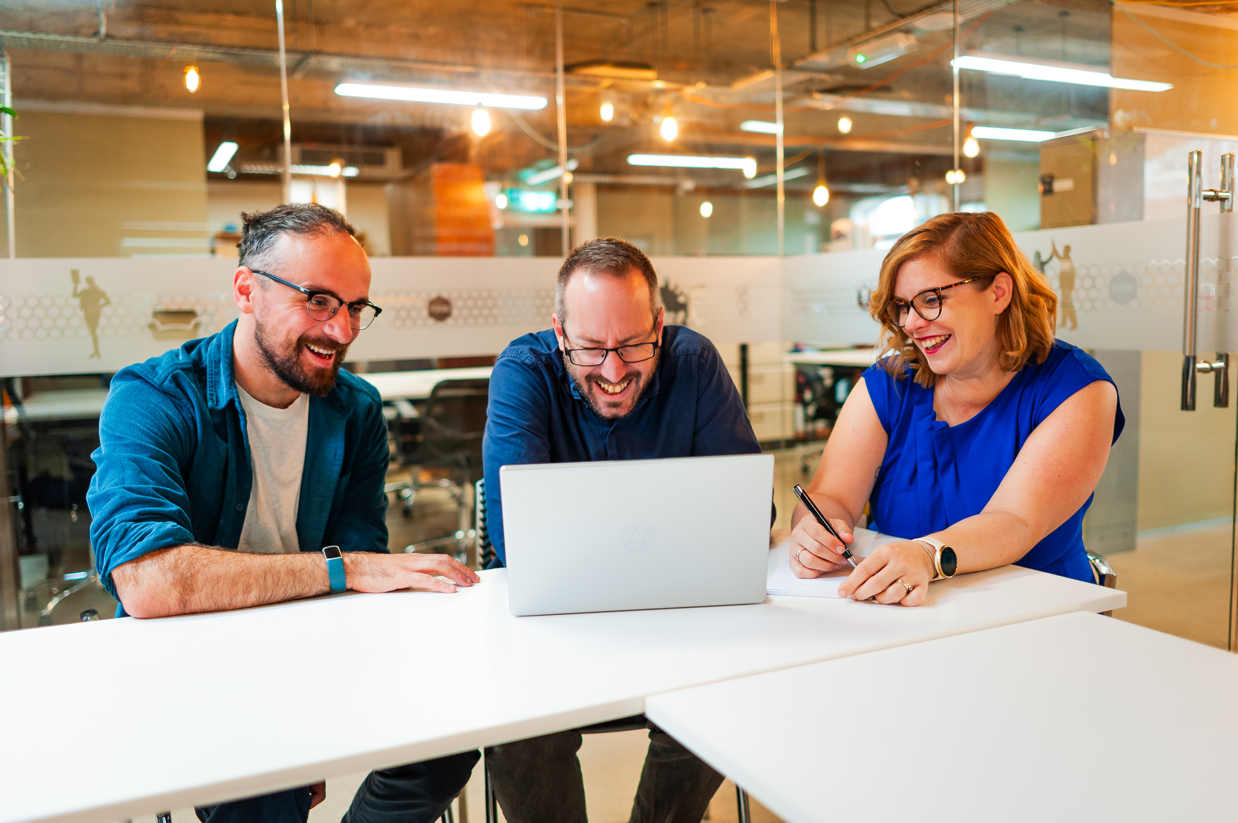 The three Alma Directors sitting together around a laptop