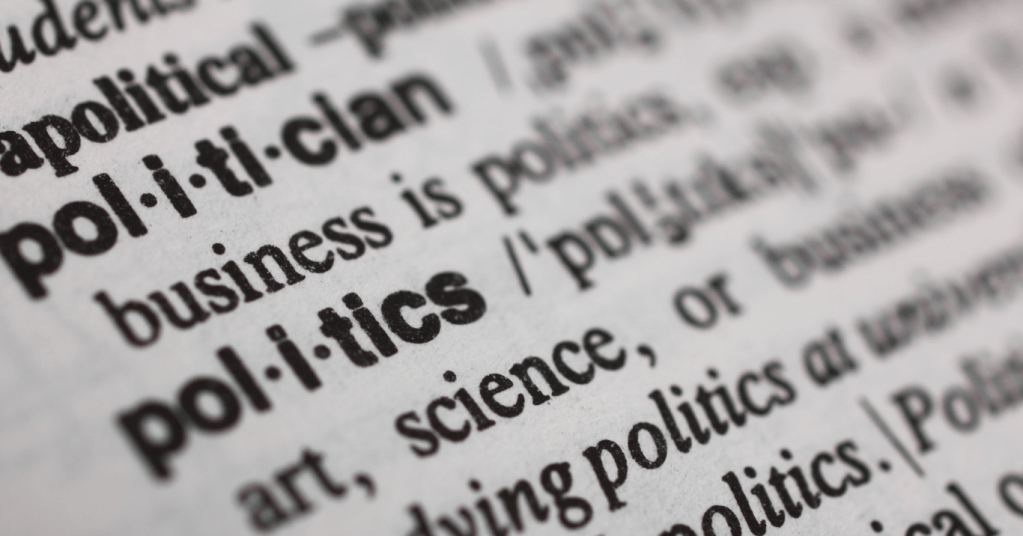 The image is zoomed into text on a page that looks like a dictionary with words like "politician" and "politics" in focus.