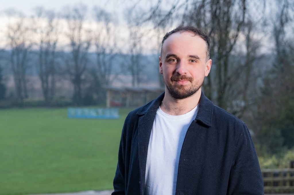 A photo of Luke facing the camera, with Avenham park behind him.