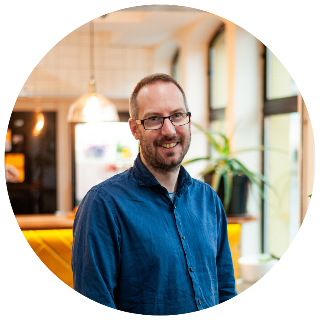 Alma Director, Ed Walker, is standing and smiling at the camera.